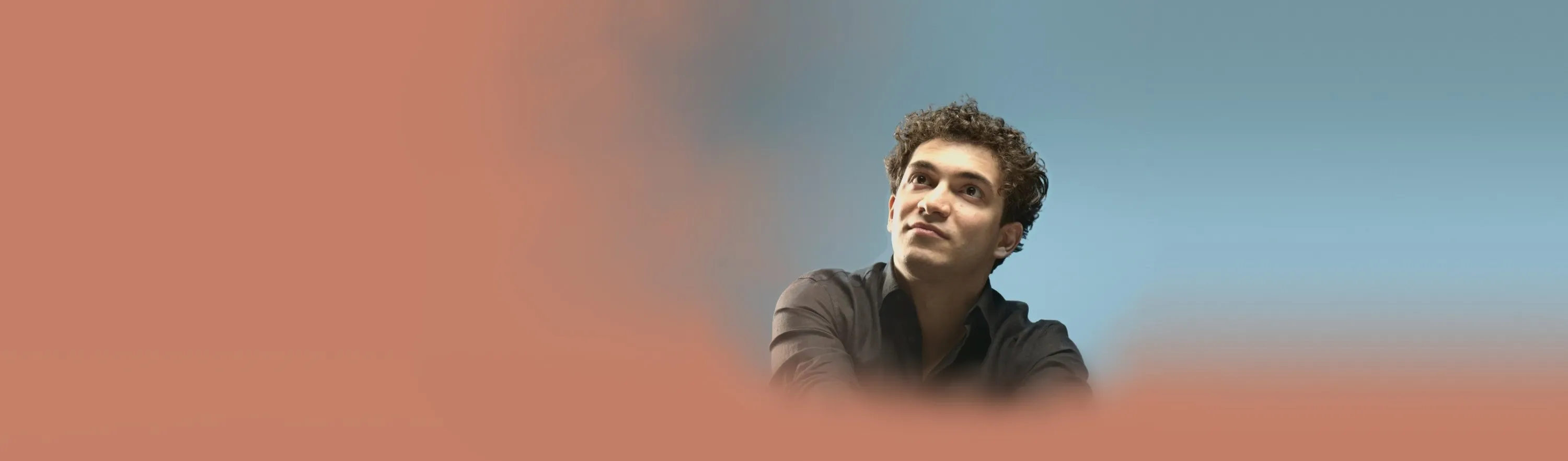 Baritone Biran Özgür Sariyer, studio portrait, looking up
