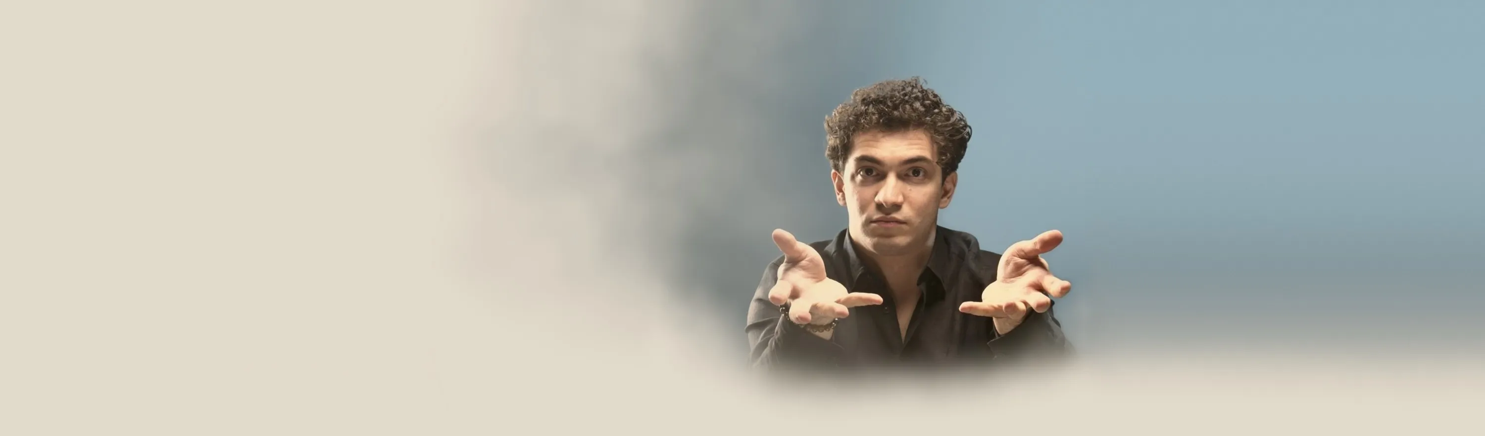 Baritone Biran Özgür Sariyer, studio portrait, open hands