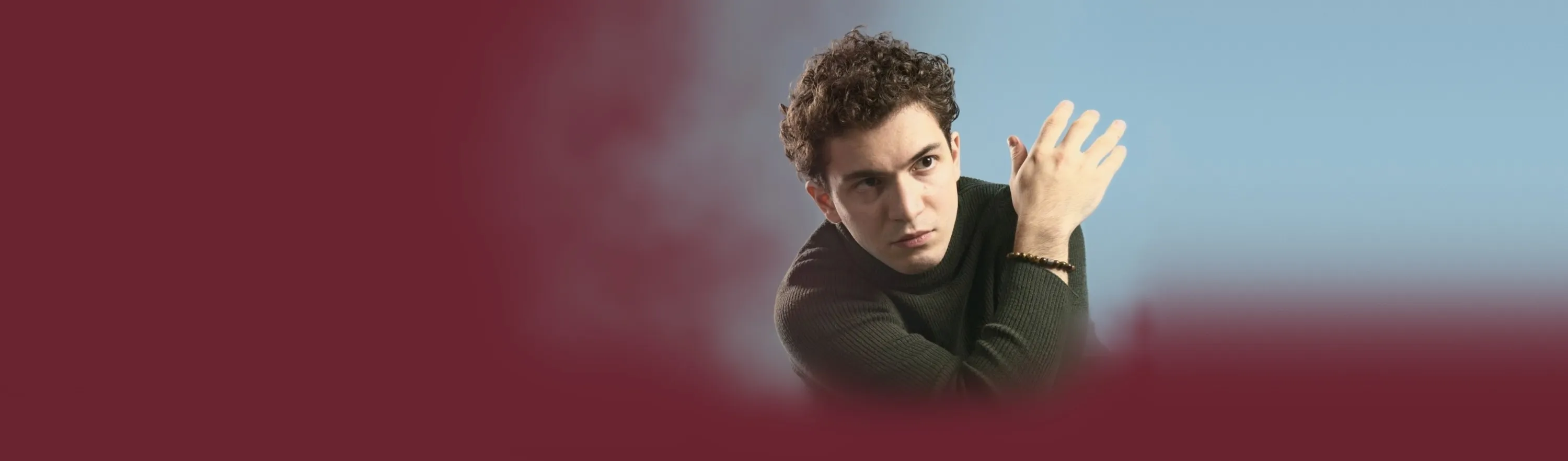 Baritone Biran Özgür Sariyer, studio portrait, theatrical gesture