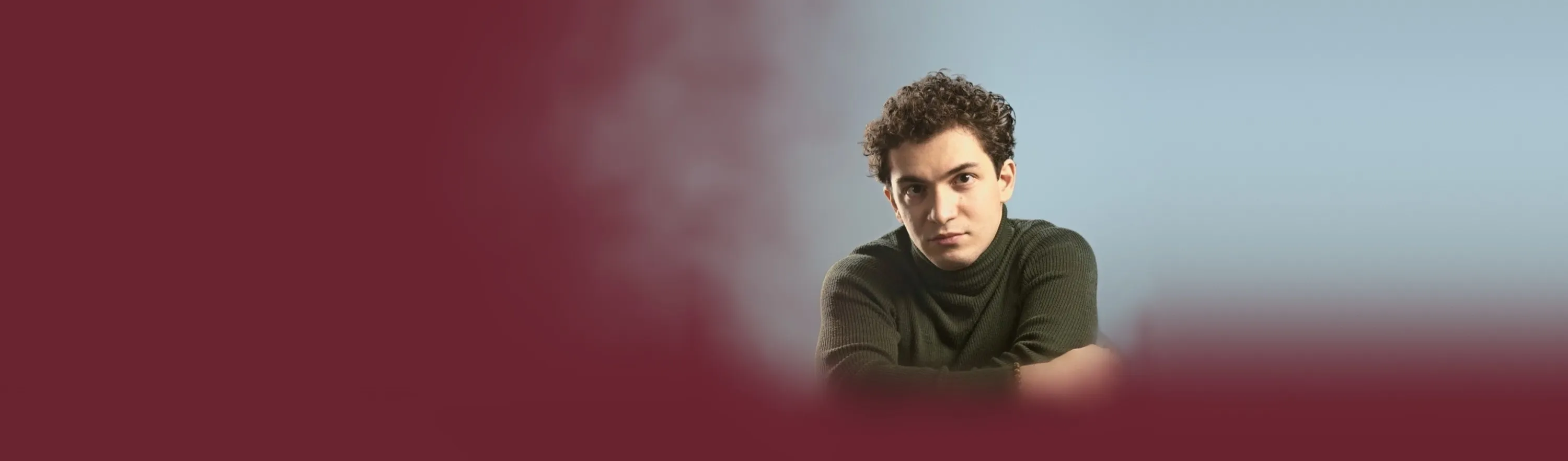 Baritone Biran Özgür Sariyer, studio portrait, green turtleneck