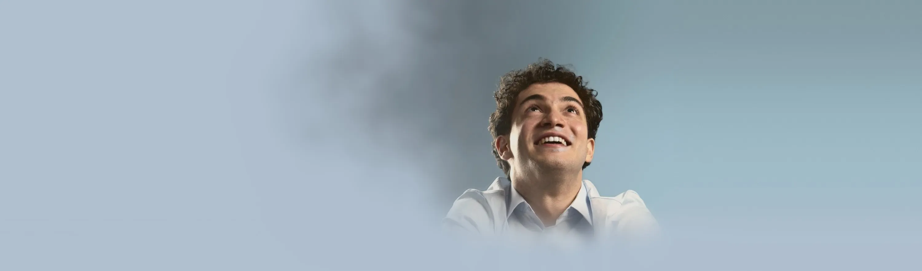 Baritone Biran Özgür Sariyer, studio portrait, looking up, smiling