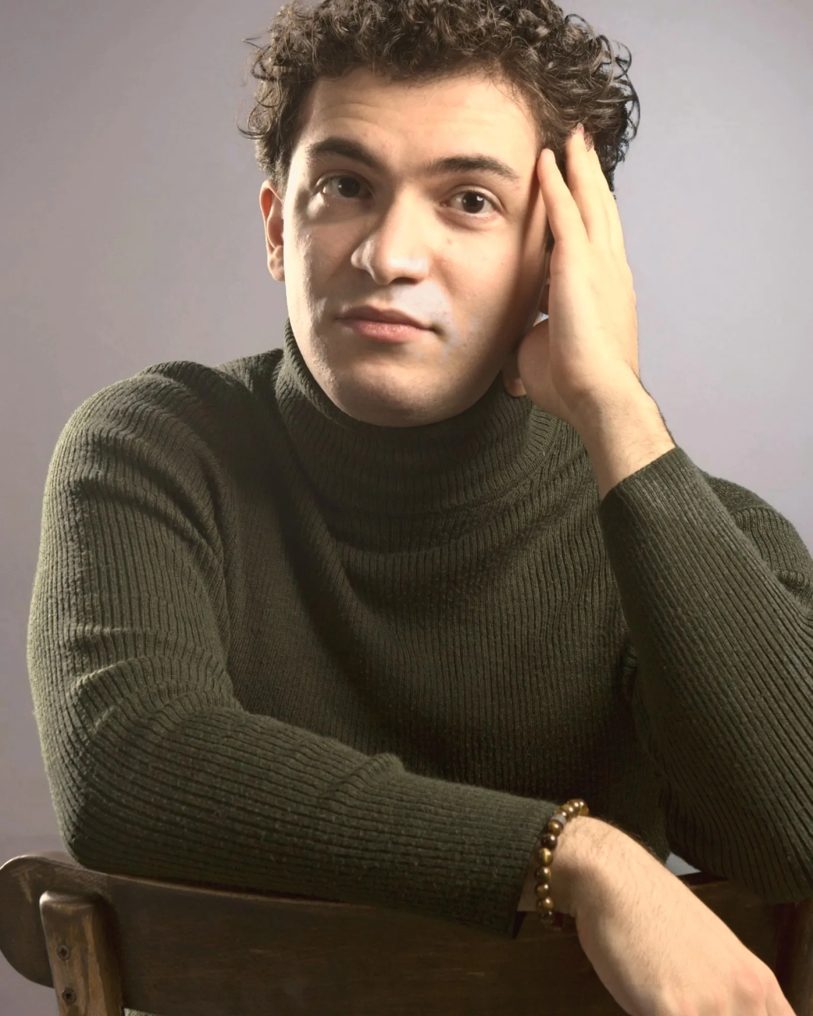 Baritone Biran Özgür Sariyer, studio portrait, thoughtful