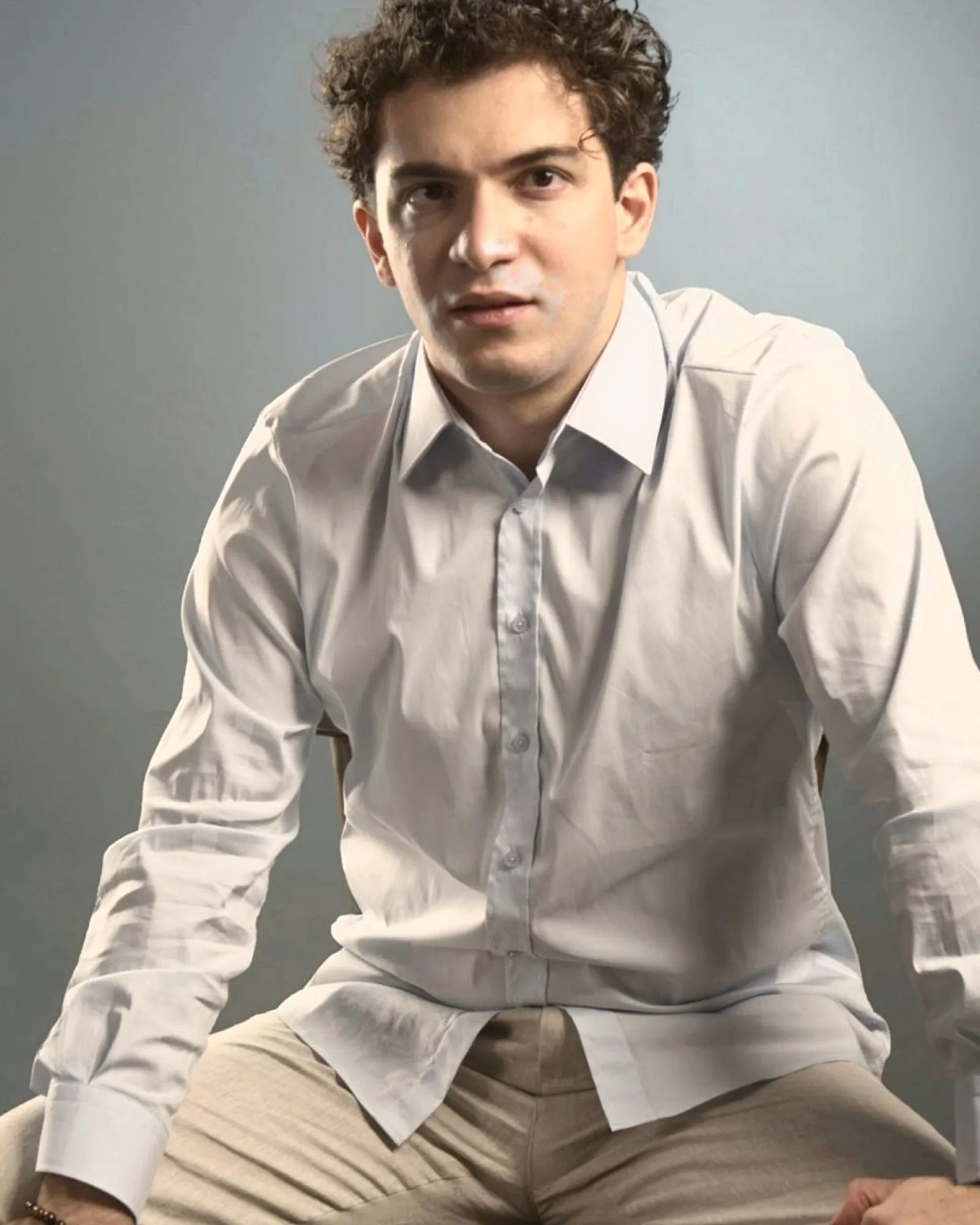 Baritone Biran Özgür Sariyer, studio portrait, seated